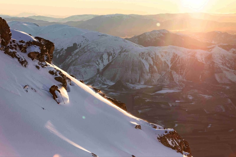 Skier in Mt Hutt backcountry with wide alpine views at sunrise